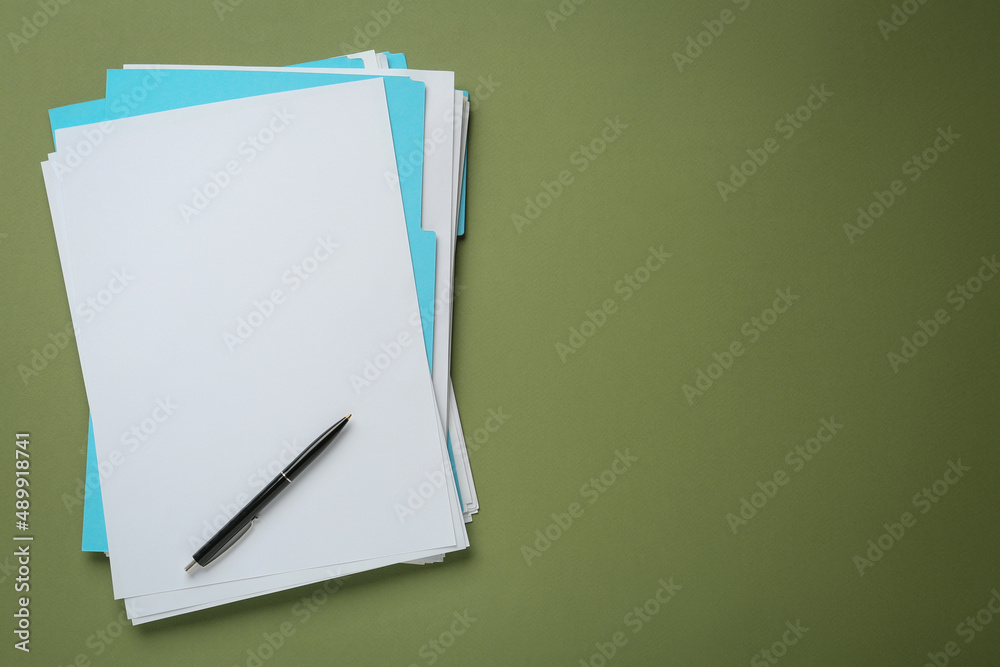 Turquoise files with blank sheets of paper and pen on olive background, top view. Space for text Turquoise files with blank sheets of paper and pen on olive background, top view. Space for text