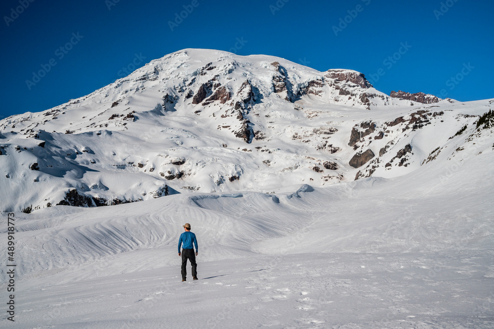 Male posing in front of Mount Rainier in the winter