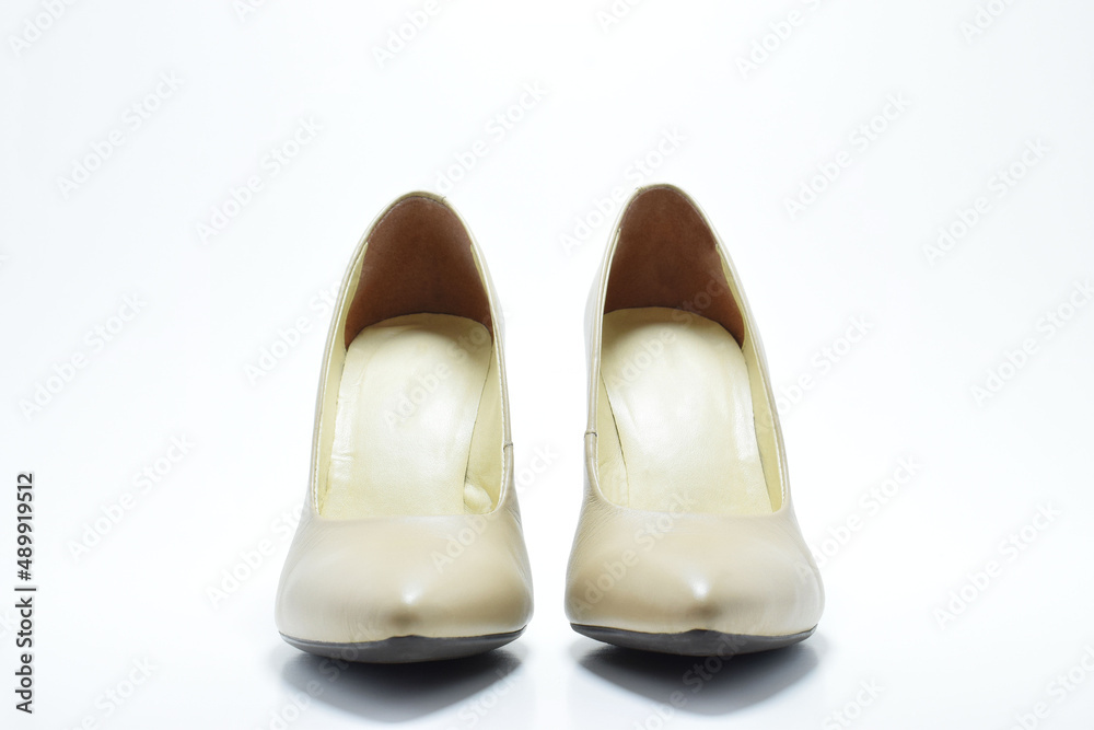Zapatos de tacón para mujer color beige. Calzado formal para fiesta o trabajo sobre un fondo blanco, vista frontal. Zapatos de tacón para mujer color beige. Calzado formal para fiesta o trabajo sobre un fondo blanco, vista frontal.