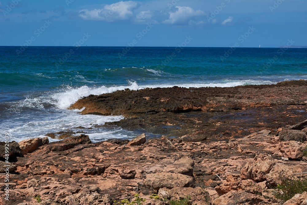 Rocks on the shore hit by the wave