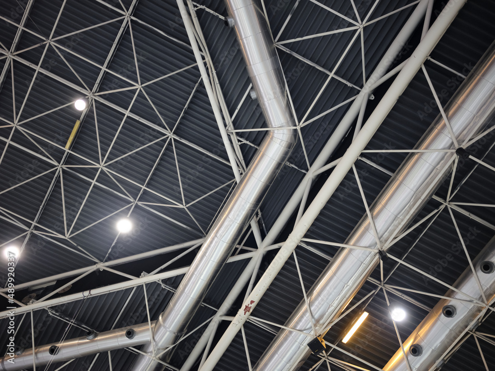Ceiling of a trade fair with tubes and lights forming geometric structures