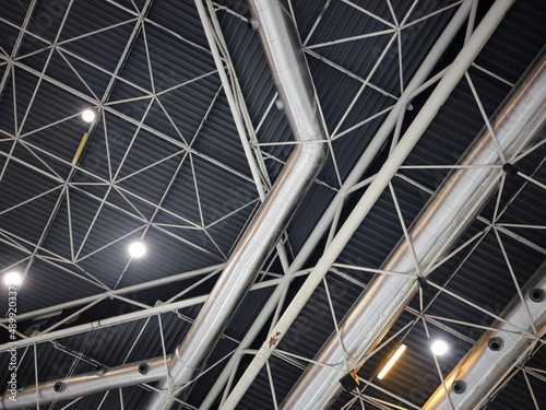 Ceiling of a trade fair with tubes and lights forming geometric structures
