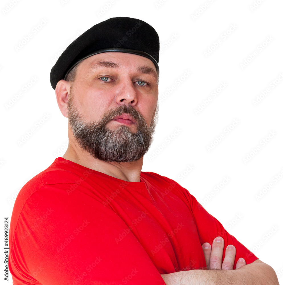 A man with a gray beard in a red T-shirt and a black beret. Bearded middle aged man isolated on white. A man with a gray beard in a red T-shirt and a black beret. Bearded middle aged man isolated on white.