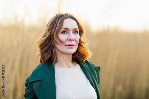 portrait of middle aged woman posing at the park