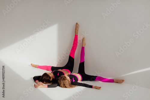 Gymnast sisters doing a trick photo