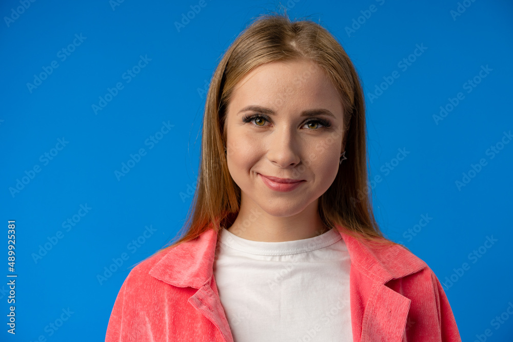 Portrait of young smiling woman looks in camera Portrait of young smiling woman looks in camera