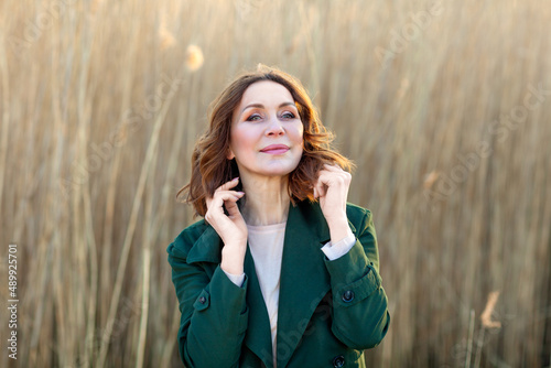 portrait of middle aged woman posing at the park