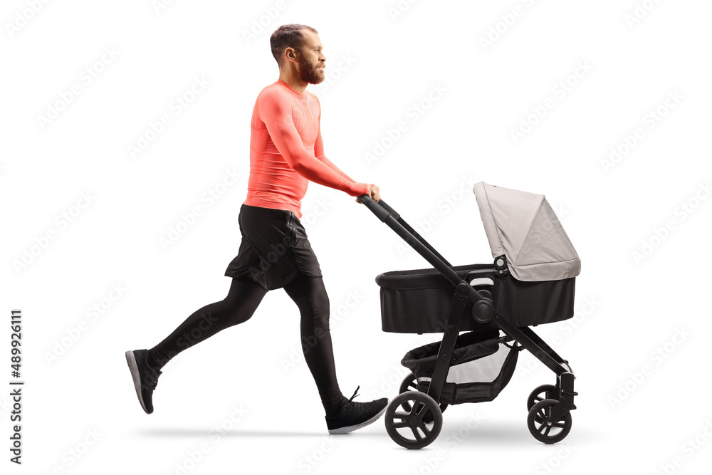 Full length profile shot of a father pushing a baby stoller and jogging Full length profile shot of a father pushing a baby stoller and jogging
