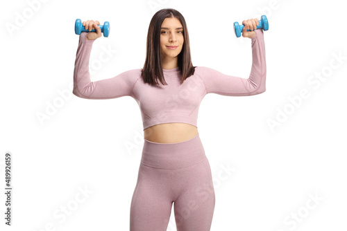 Fit young female exercising with dumbbells