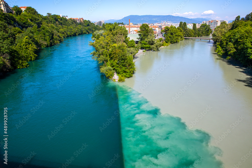 Arve Rhone River Junction (La Jonction) in Geneva, Switzerland. The river with two colors -- where the emerald blue water from the Rhone converge and blend with the silty water from the Arve