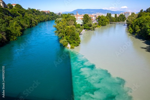 Arve Rhone River Junction (La Jonction) in Geneva, Switzerland. The river with two colors -- where the emerald blue water from the Rhone converge and blend with the silty water from the Arve photo