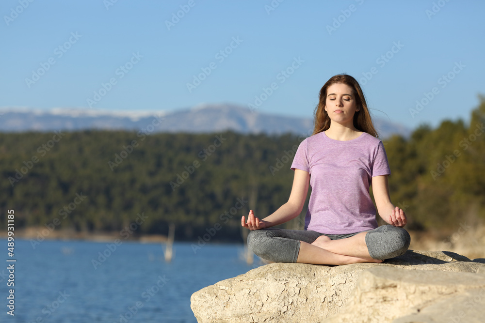 Young woman doing yoga in a lake Young woman doing yoga in a lake