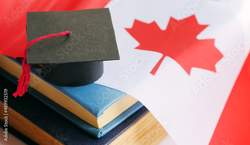 Fotografie Graduation cap on stack of books