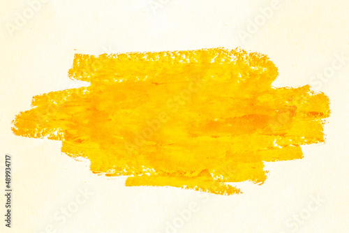 Smear of yellow paint on a white background. Cosmetics, makeup. Isolated template for design. Golden