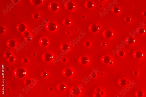 Bubble red background texture. Berry gel to cleanse the skin of the face and body. Spa treatments  skin care. Bath foam  detergent. Slime pink.