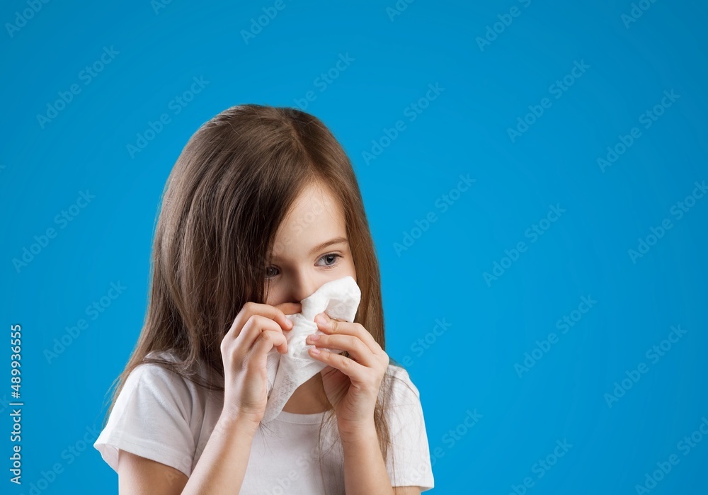 Young kid feels unwell, blows nose in tissue, suffers from running nose, cold symptoms or allergy Young kid feels unwell, blows nose in tissue, suffers from running nose, cold symptoms or allergy