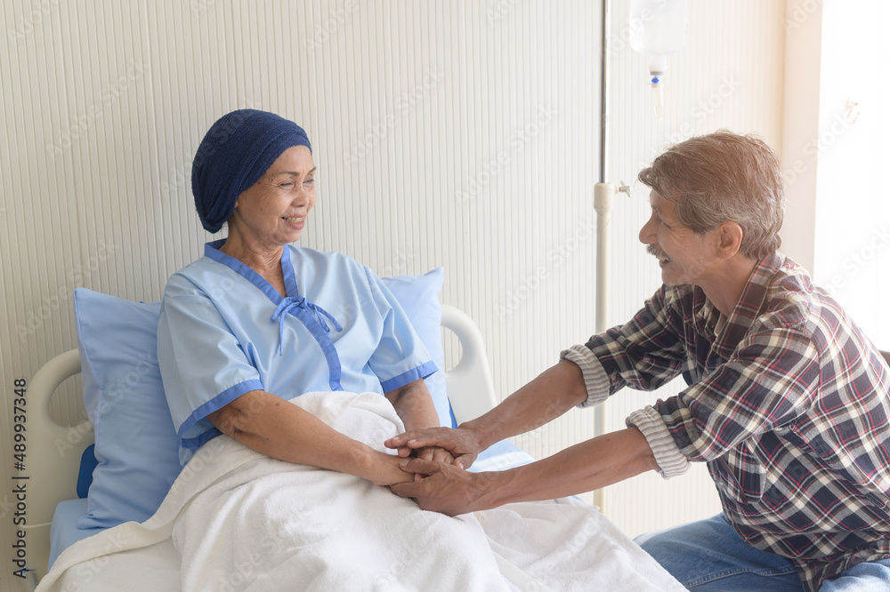 Senior man visiting cancer patient woman wearing head scarf at hospital, health care and medical concept Senior man visiting cancer patient woman wearing head scarf at hospital, health care and medical concept