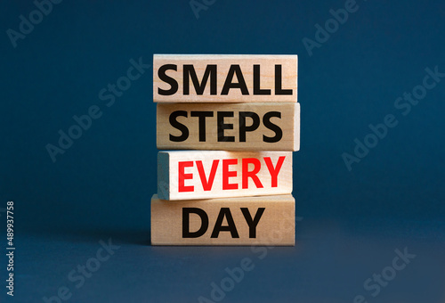 Small steps every day symbol. Concept words Small steps every day on wooden blocks. Beautiful grey table grey background. Small steps every day business concept. Copy space.
