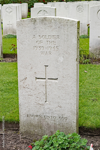 A white marble headstone stands in memory of those  who died during WW II but remain unknown. Arnhem, Netherlands.