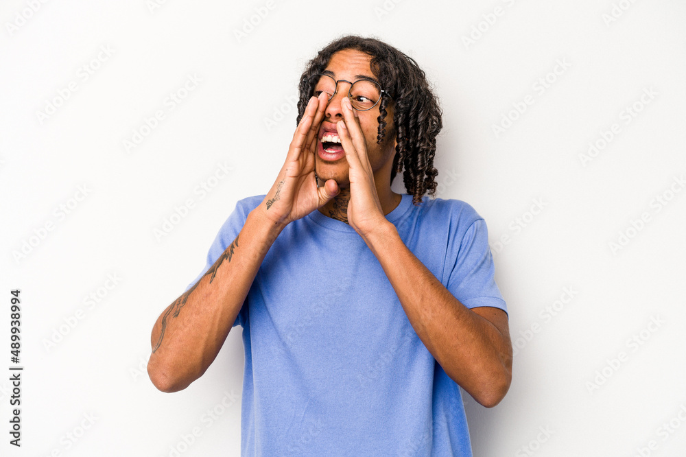 Young African American man isolated on white background shouting excited to front. Young African American man isolated on white background shouting excited to front.
