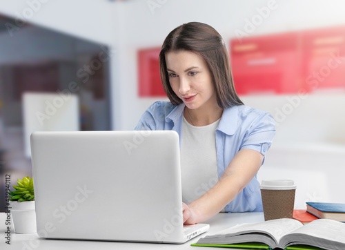 Happy young woman student having video call virtual meeting working or remote learning at home