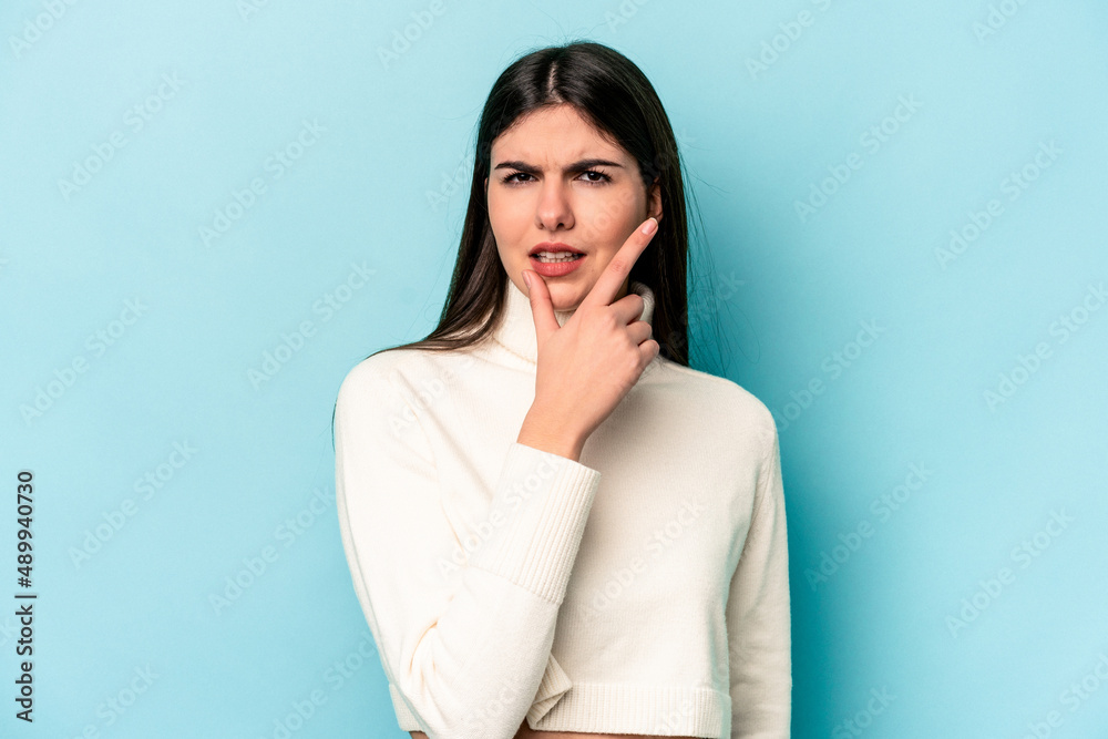 Young caucasian woman isolated on blue background contemplating, planning a strategy, thinking about the way of a business. Young caucasian woman isolated on blue background contemplating, planning a strategy, thinking about the way of a business.