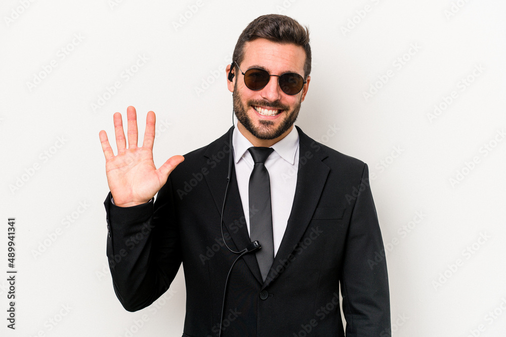 Young caucasian bodyguard man isolated on white background smiling cheerful showing number five with fingers.