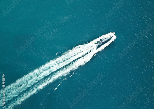Eat my wake. High angle shot of a boat speeding through the water. © Anne/peopleimages.com