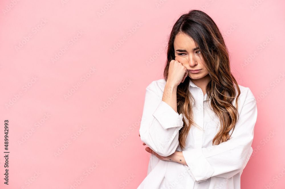 Young caucasian woman isolated on pink background who feels sad and pensive, looking at copy space. Young caucasian woman isolated on pink background who feels sad and pensive, looking at copy space.