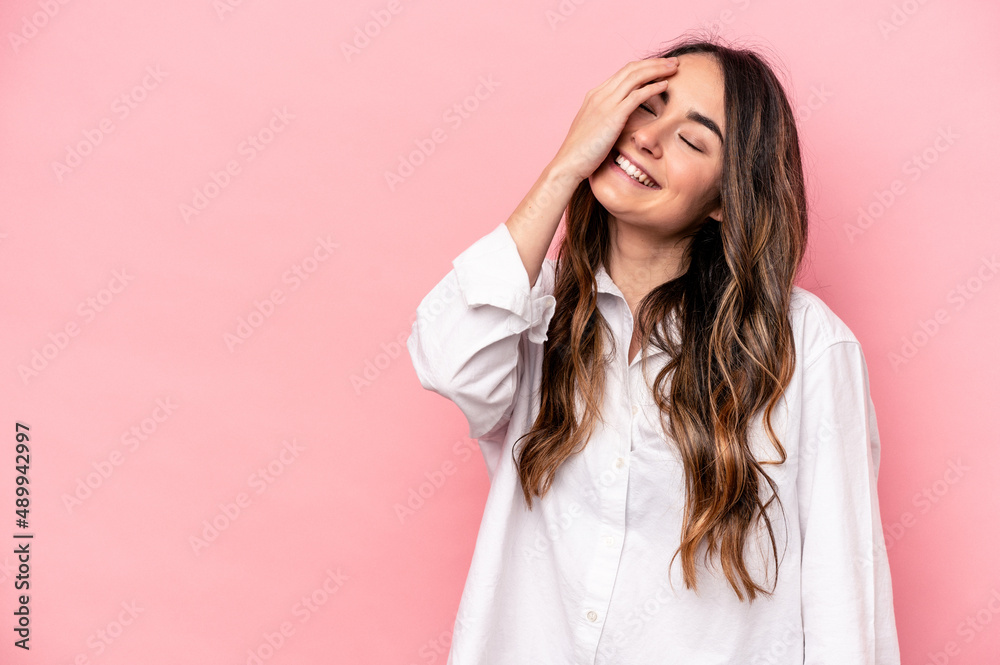 Young caucasian woman isolated on pink background laughing happy, carefree, natural emotion. Young caucasian woman isolated on pink background laughing happy, carefree, natural emotion.