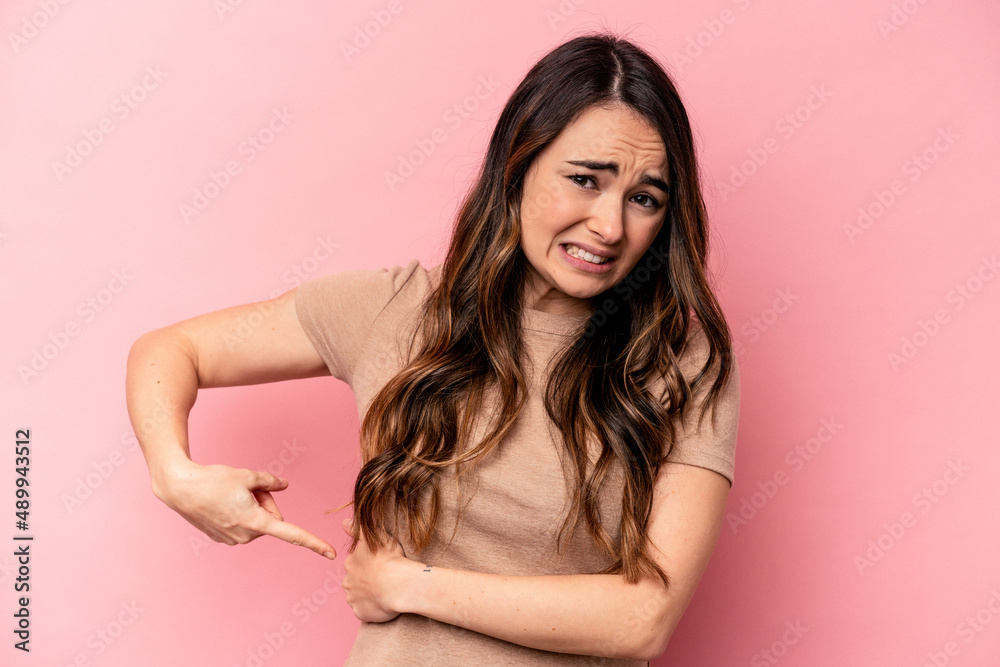 Young caucasian woman isolated on pink background having a liver pain, stomach ache. Young caucasian woman isolated on pink background having a liver pain, stomach ache.
