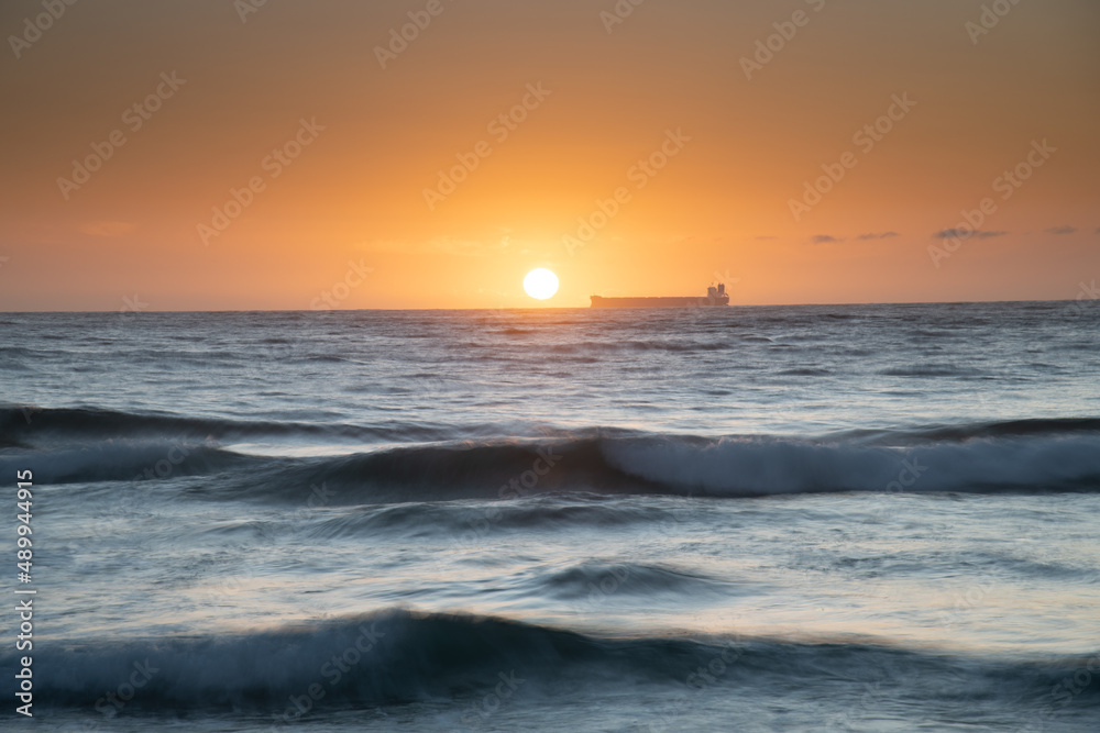 Sun, sand, ship sunrise seascape