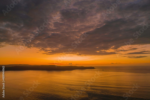 Aerial sunrise seascape with low clouds