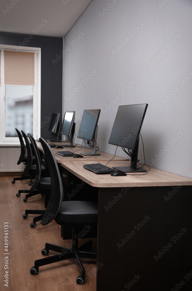 Many modern computers in open space office Many modern computers in open space office