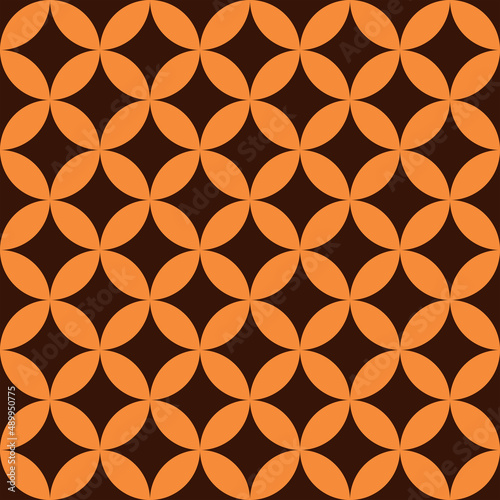 Mid century modern 60s seamless pattern in orange shapes over dark brown background. Great for home décor, wallpaper and textile 