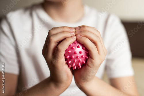 self-massage of hands with a ball with spikes
