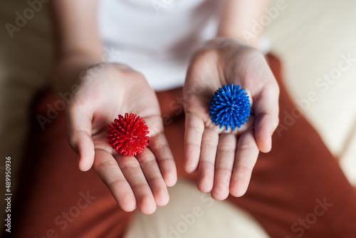 self-massage of hands with a ball with spikes