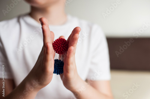 self-massage of hands with a balls with spikes