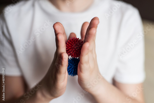 self-massage of hands with a ball with spikes