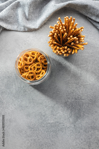 Mini pretzels and salted sticks. Crusty salted snack on kitchen table.