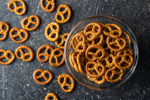 Mini pretzels. Crusty salted snack in bowl.