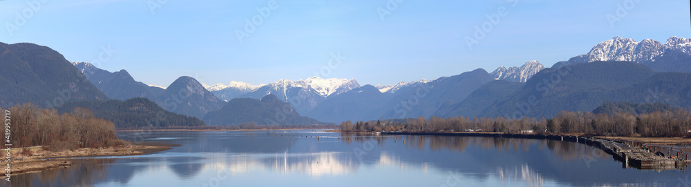 Winter scenery made of tranquil river and snow-capped mountains