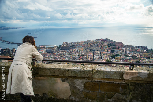 woman lay over a balcony from the castle overlooking the Napoli