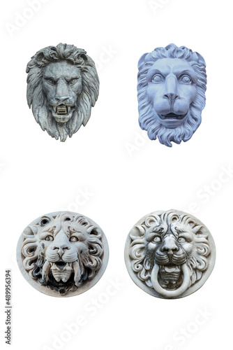 four plaster sculptures of lions heads isolated on white background
