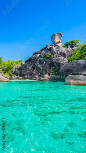 Beautiful landscape people on rock is a symbol of Similan Islands, blue sky and cloud over the sea during summer at Mu Ko Similan National Park, Phang Nga province, Thailand