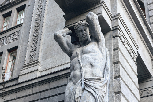 fragment of sculpture Atlanta in the arch of a residential building in the Russian city of St. Petersburg, Russia photo