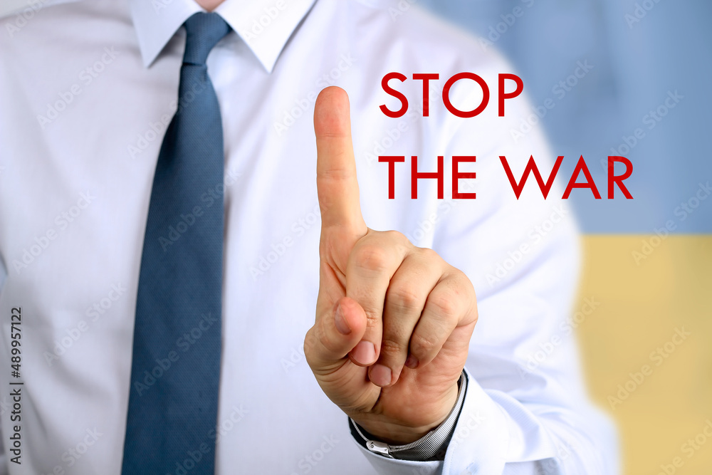 Businessman is pointing out a phrase STOP THE WAR Businessman is pointing out a phrase STOP THE WAR