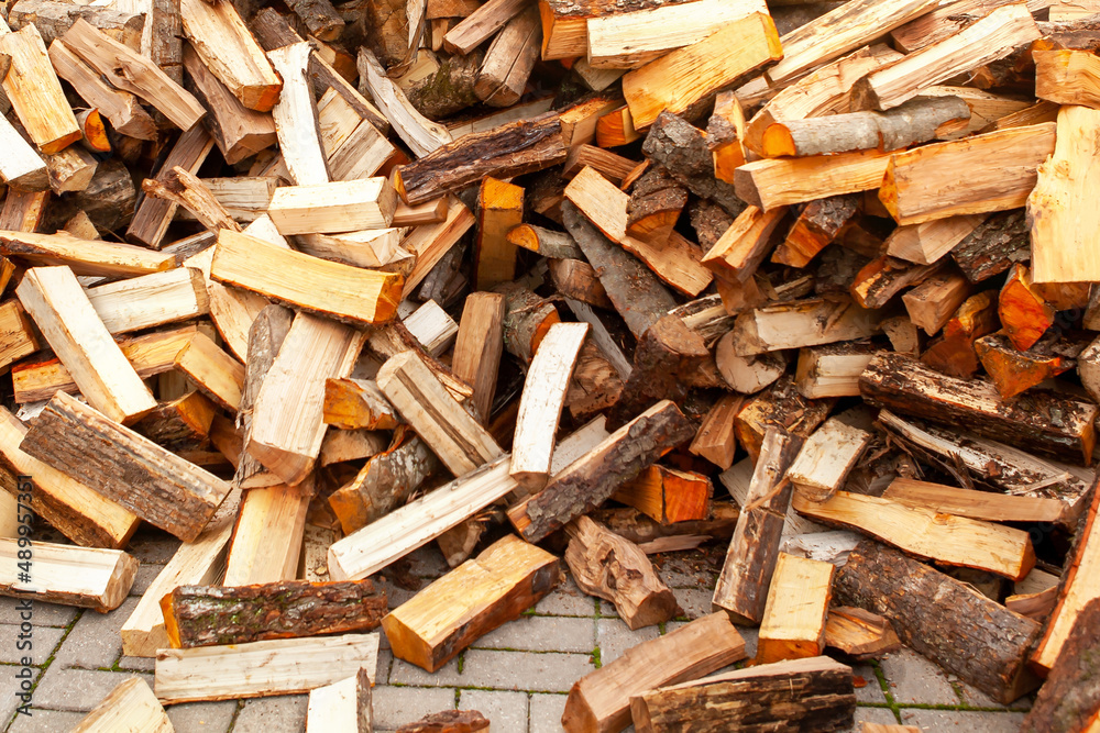Background in the form of firewood chopped for heating the house, stacked randomly. Closeup. Background in the form of firewood chopped for heating the house, stacked randomly. Closeup.