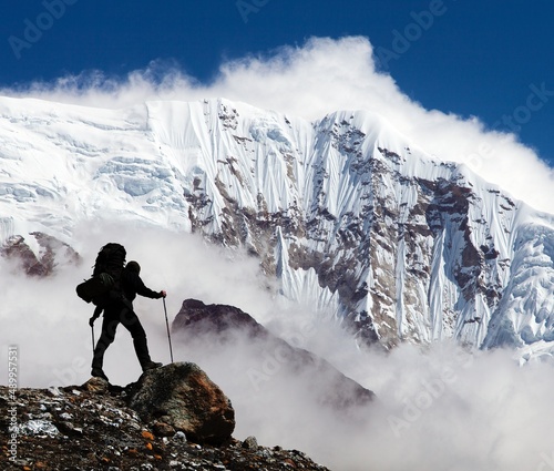 Silhouette of man and mountains with clouds photo