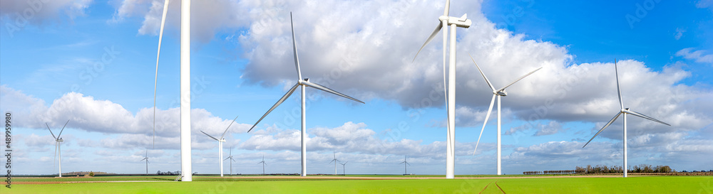 Fototapeta premium Panoramic view of a large field of wind turbines green energy.